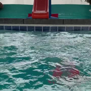 Lana sliding/diving off slide