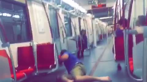 Blue shirt guy on train runs falls and slides head first into seats