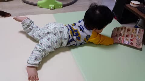 This is a video of a baby crawling doing her best to catch a flyer.