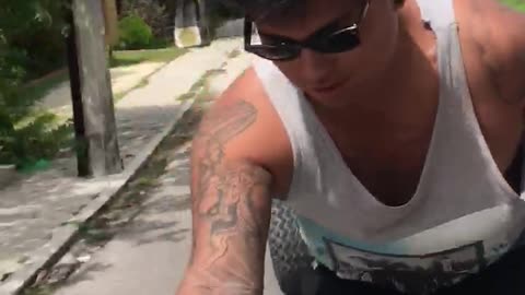 Sunglasses guy tries running from golf cart but falls down and almost run over