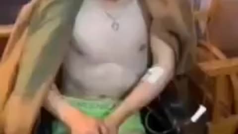 Russian Solider stripped down to underwear and written on his head questioned
