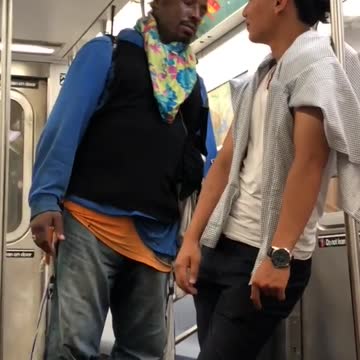 Man in blue shirt confronting man in white shirt