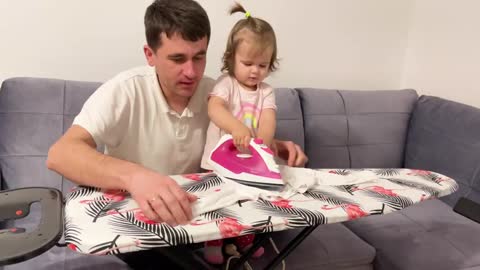 A_Cute_Baby_Irons_a_T_shirt_for_the_First_Time