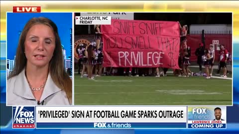 Parents outraged over 'privileged' sign at high school football game