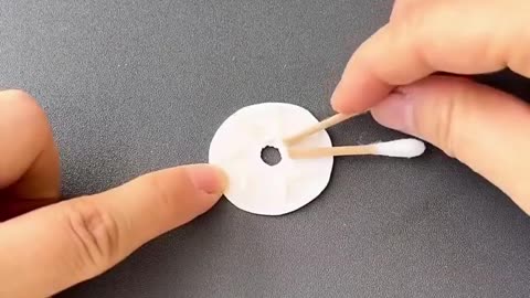 You can make a rotating Ferris wheel with cotton swabs and small bottle caps