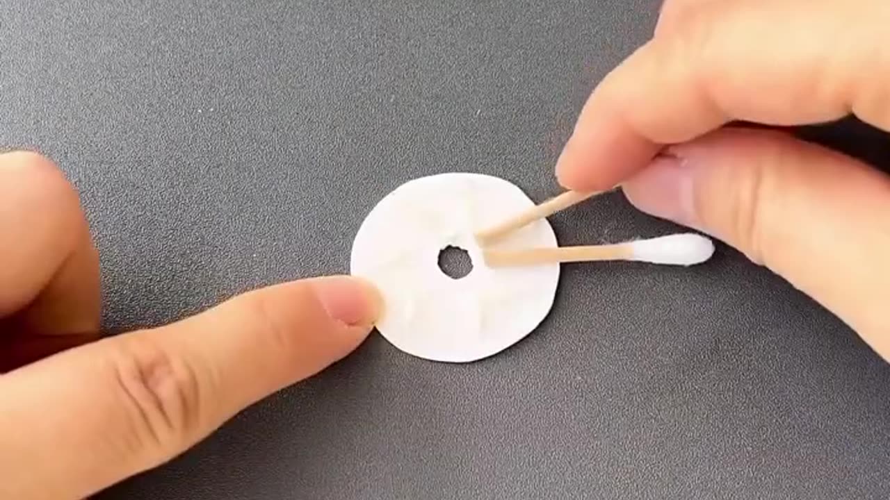 You can make a rotating Ferris wheel with cotton swabs and small bottle caps