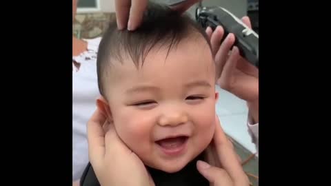 Little boy enjoys his haircut