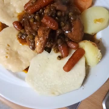 Stew chicken and cornmeal dumplings with yam and sweet potato