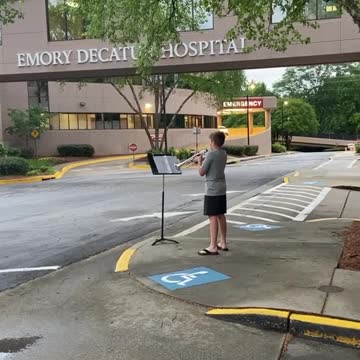 12-year-old boy plays trumpet for healthcare workers