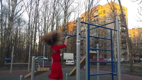 Strong Russian girl on the horizontal bar