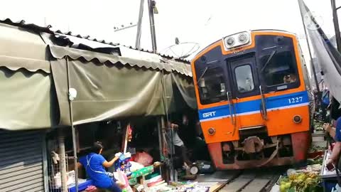 Market train run through Thailand Most Dangerous market train video