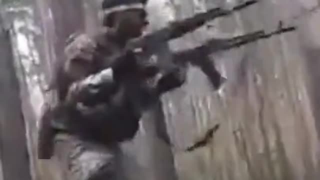 Chechen soldier fires double AKs!