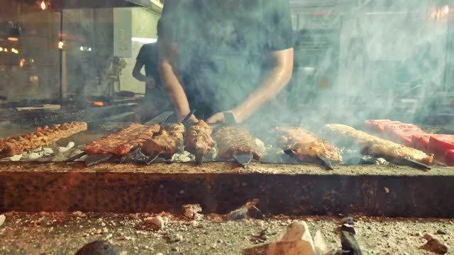 Man preparing some delicious pieces of meat in a Turkish restaurant at Cappadocia, Turkey.