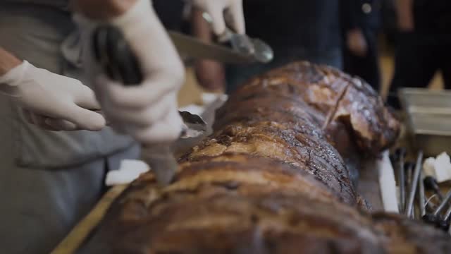 chefs chop juicy meat of baked pork grill chefs hands