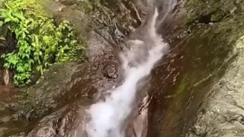 A group of people slide down the mountain stream, which is exciting.