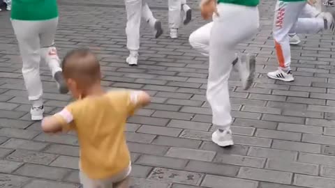 Boy dancing with adults