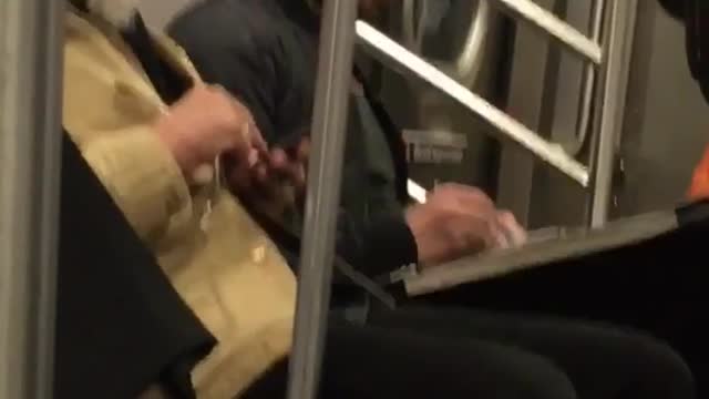 Guy drawing girl on subway