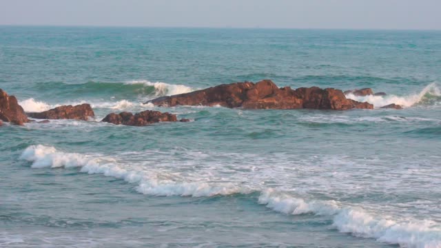 Rocks, waves, clear sea