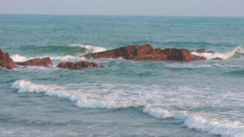 Rocks, waves, clear sea