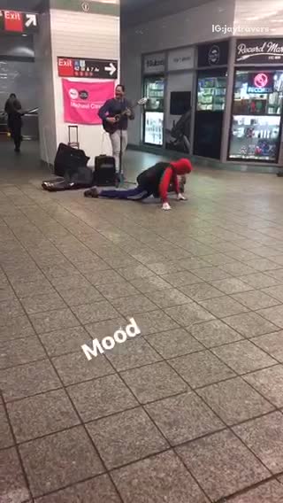 Person in spiderman outfit dances to subway music
