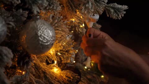 Putting baubles on the Christmas tree