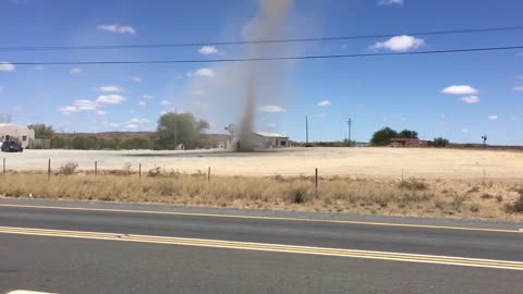 A Man Walks Through A Small Tornado