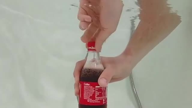 What happens if Coca-Cola is placed under water