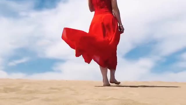 Beautiful girl walking on the sand