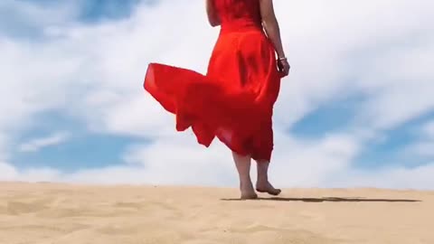 Beautiful girl walking on the sand