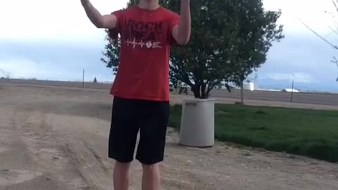 Music kid in red shirt kicks soccer ball up into his face