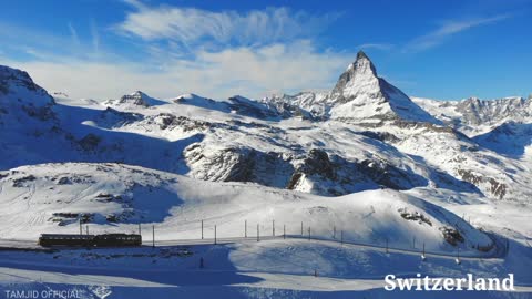Train Transporting Public Above The Mountains Alps Of Switzerland