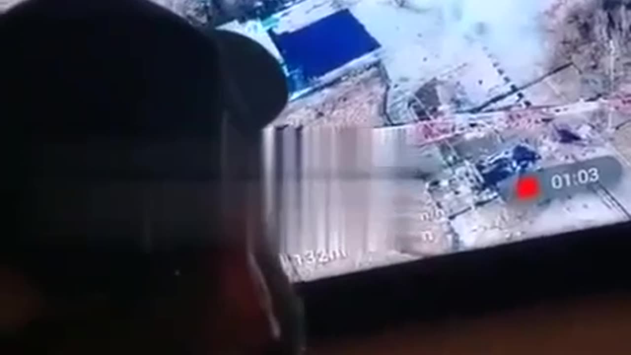 Russian soldiers watch as a Ukrainian tank blows itself up