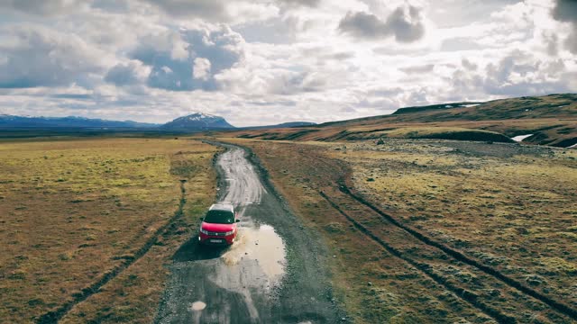 Red Car on A Dirt Road