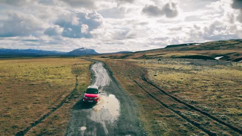 Red Car on A Dirt Road