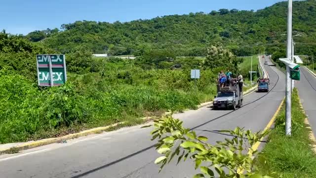 Mexico: Several vehicles packed full of migrants from the caravan roll into Pijijiapan, Chiapas.