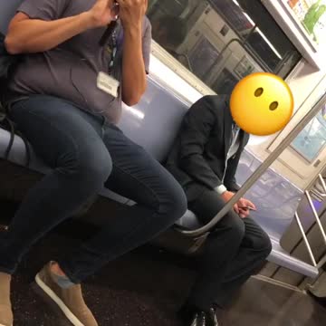 Man on train taking pictures of people