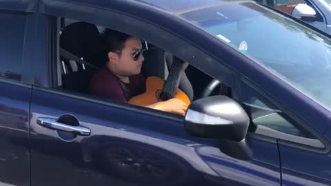 Musician Multitasks on Auckland Motorway