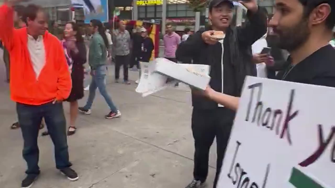 Iranians hold a street party in Toronto and hand out cake in celebration of Israel