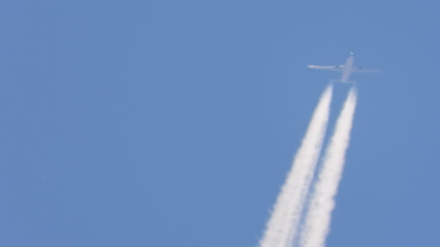 Airplanes drawing white lines in the sky.