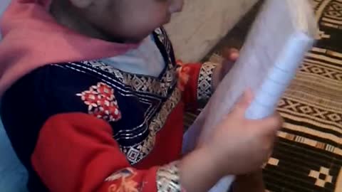 Bul Bul ka bacha.a little girl trying to read a poem