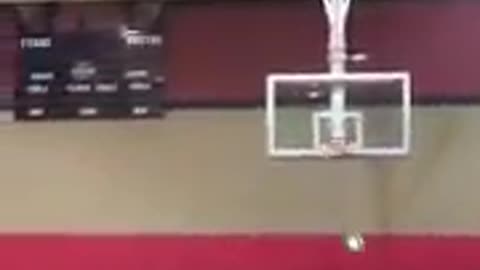 Boy in black kicks ball makes basket