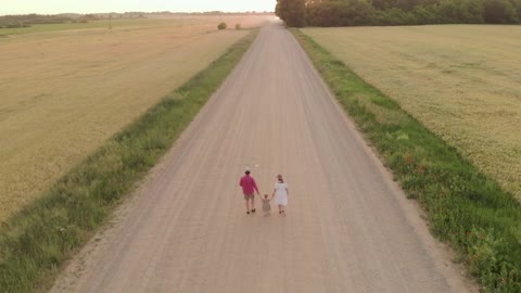 Mom and Dad with their child on a walk.