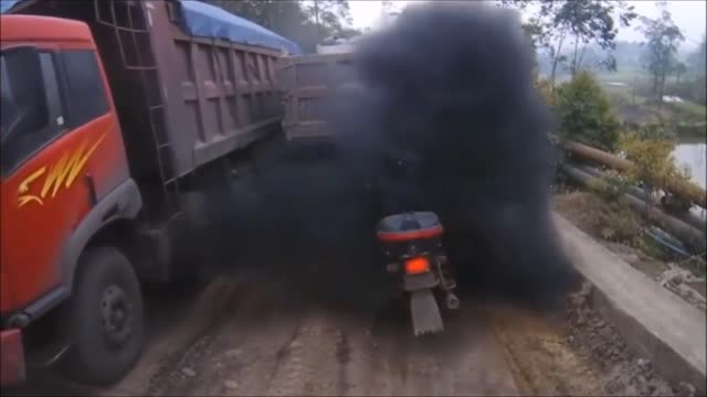 Diesel Truck Blowing black smoke at Motorcyclist.