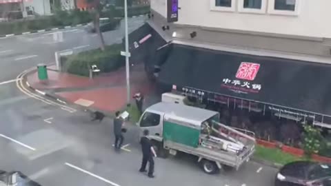 Husband tries to chop his wife in the street