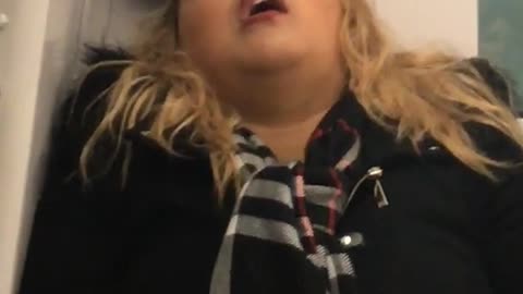 Blonde girl in minnie mouse ears asleep in back of train