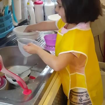 Helpful Little Girl Loves To Assist With The Dishes