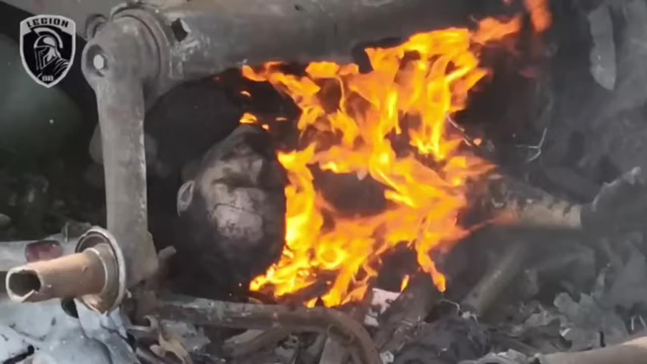 A Russian fascist burns in the remnants of destroyed equipment