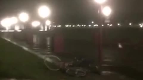 Black jacket on bicycle falls down on grass hill at night