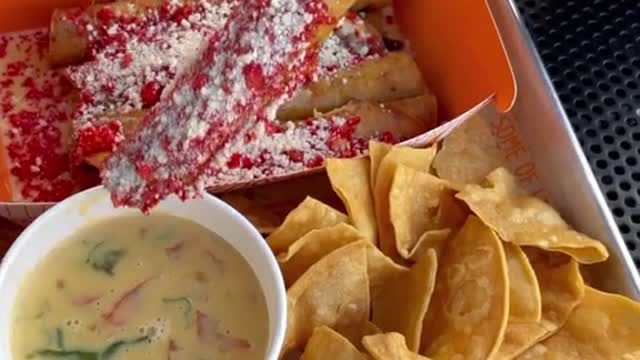 Handmade Taquitos with hot Cheetos and queso. Who else like hot Cheetos