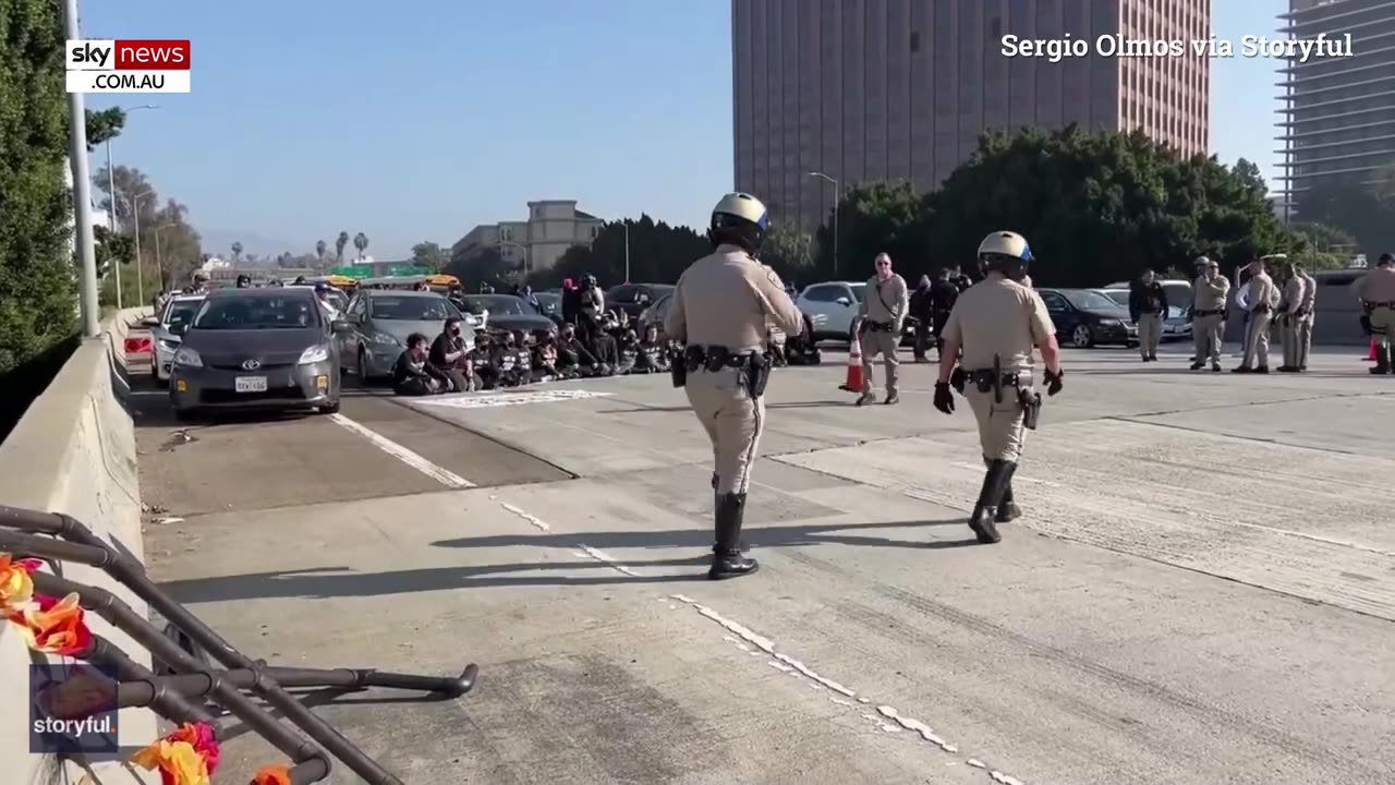 Protesters block major LA freeway and clash with commuters